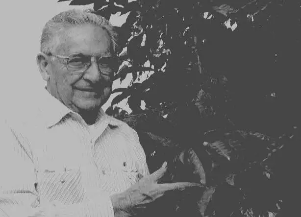Retrato historico del fundador junto a planta de cafe